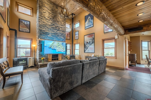 living room featuring a towering ceiling, plenty of natural light, and wood ceiling