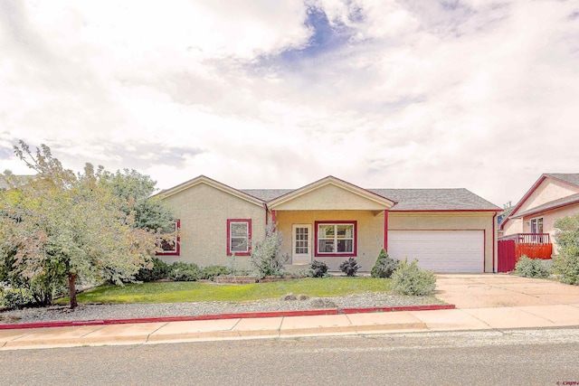 ranch-style home featuring stucco siding, a front lawn, driveway, fence, and an attached garage