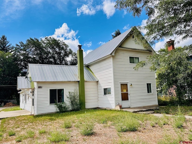 back of house with a lawn