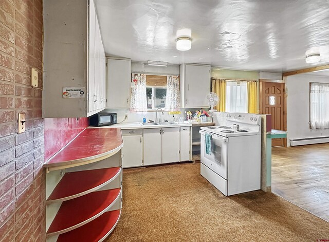 kitchen with white cabinets, sink, and range with electric stovetop