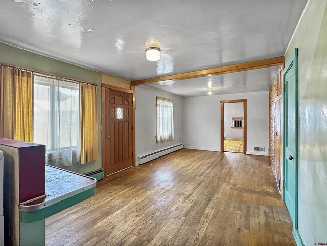 foyer featuring hardwood / wood-style floors, a baseboard heating unit, and beamed ceiling