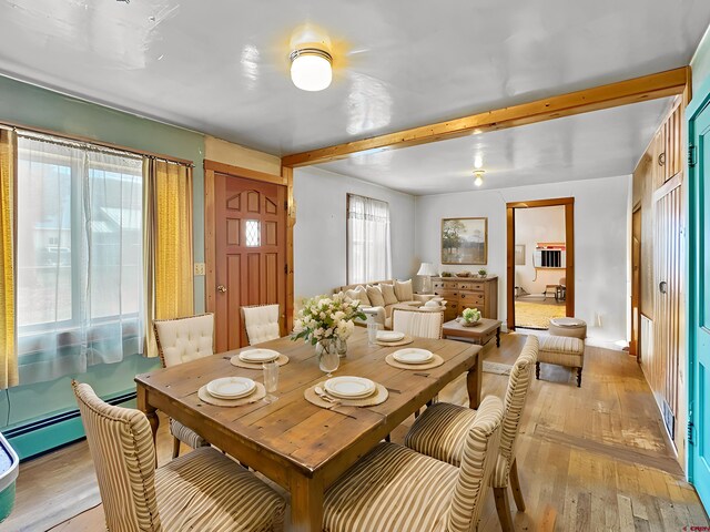 carpeted spare room featuring a baseboard radiator and wooden walls