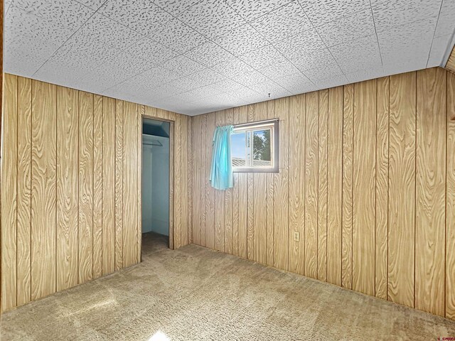 bathroom featuring tile walls, a textured ceiling, and tiled shower / bath