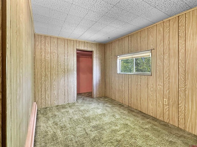 bathroom with tile walls, toilet, sink, and baseboard heating