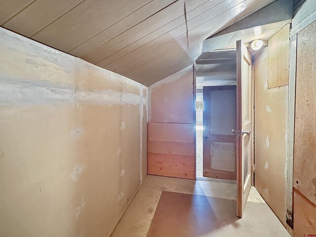 home office with a barn door, a paneled ceiling, wooden walls, a baseboard radiator, and light hardwood / wood-style flooring