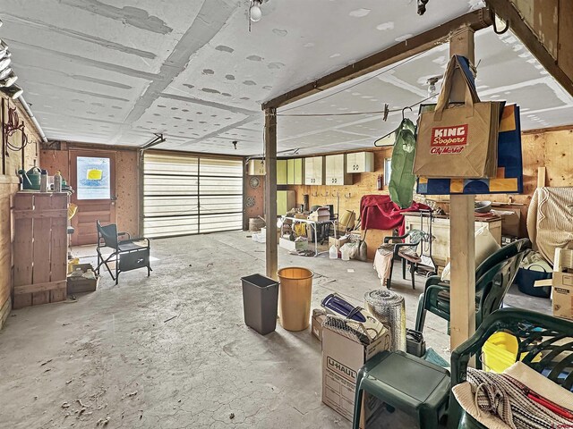 dining space with light wood-type flooring, a baseboard radiator, and beam ceiling