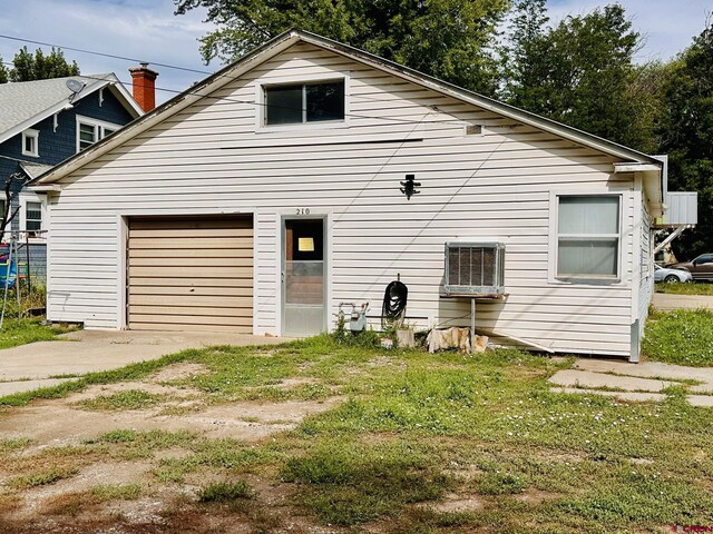 rear view of property featuring a garage