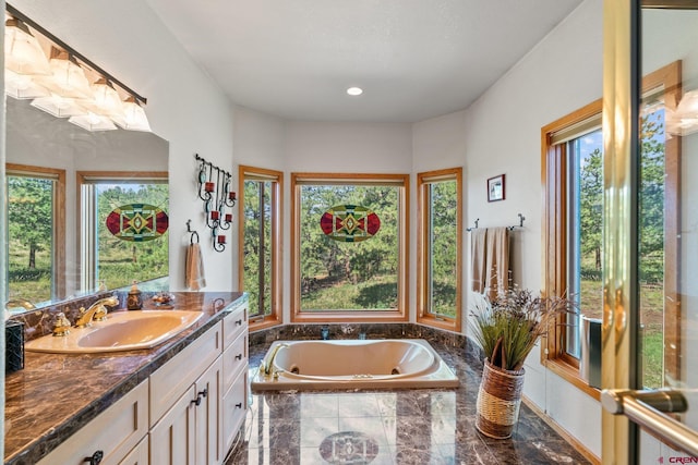 bathroom with a bath and vanity