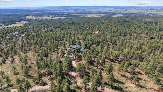 aerial view featuring a wooded view