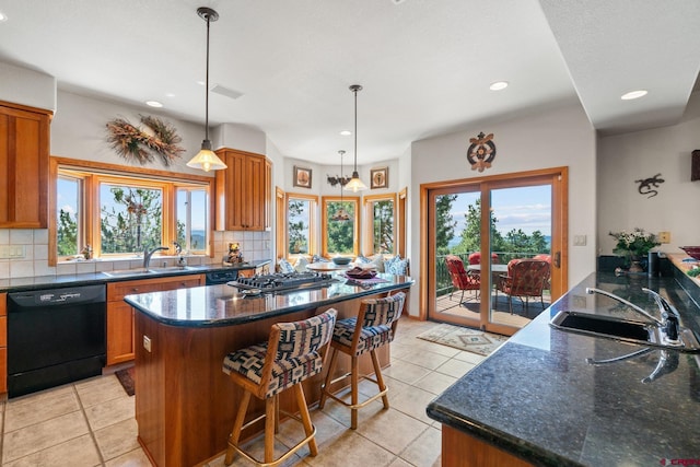 kitchen with a sink, brown cabinets, dishwasher, and stainless steel gas cooktop