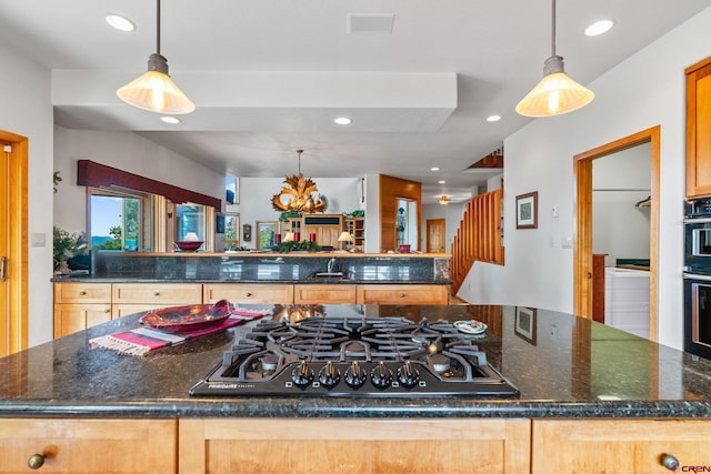 kitchen with recessed lighting, a sink, decorative light fixtures, black gas stovetop, and a center island