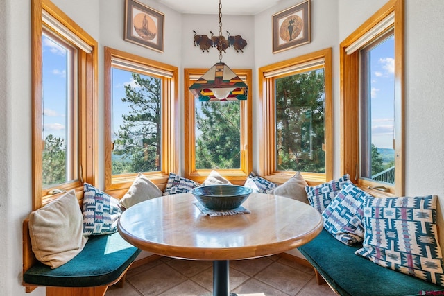 dining area featuring tile patterned floors and breakfast area