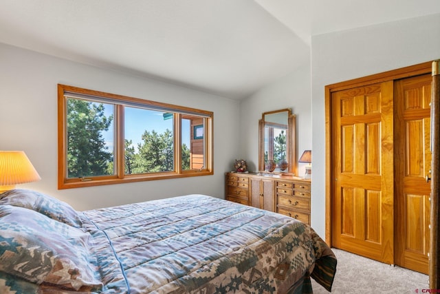 bedroom with light carpet and lofted ceiling