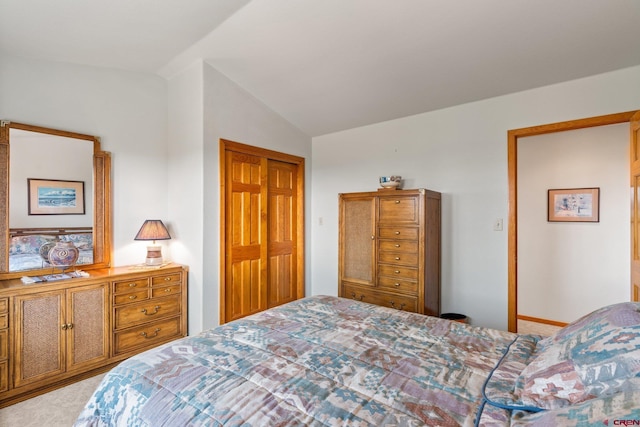 bedroom featuring a closet, carpet, and vaulted ceiling