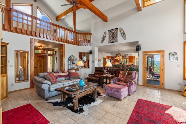 living area featuring beamed ceiling, high vaulted ceiling, a ceiling fan, tile patterned flooring, and baseboards