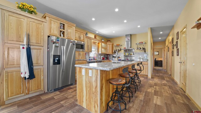 37105 Ii Rd, Redvale, CO 81431 - kitchen with light brown cabinets, stainless steel appliances, a center island, wall chimney exhaust hood, and a kitchen bar