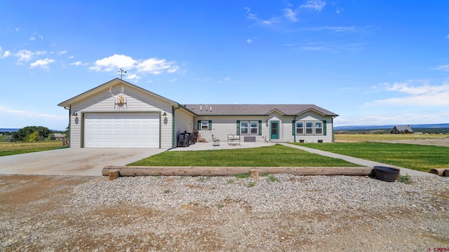 ranch-style home featuring a garage, a front yard, and driveway