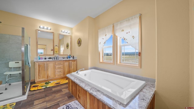 37105 Ii Rd, Redvale, CO 81431 - full bathroom featuring a garden tub, wood finished floors, a shower stall, and vanity