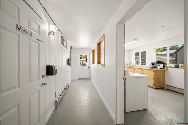 corridor featuring baseboard heating and a textured ceiling