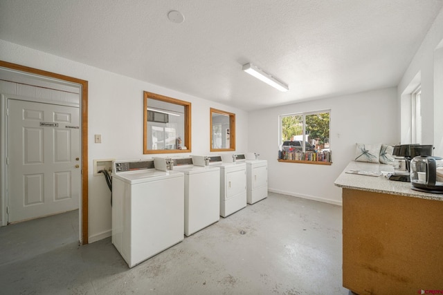 clothes washing area featuring washer and dryer and a textured ceiling