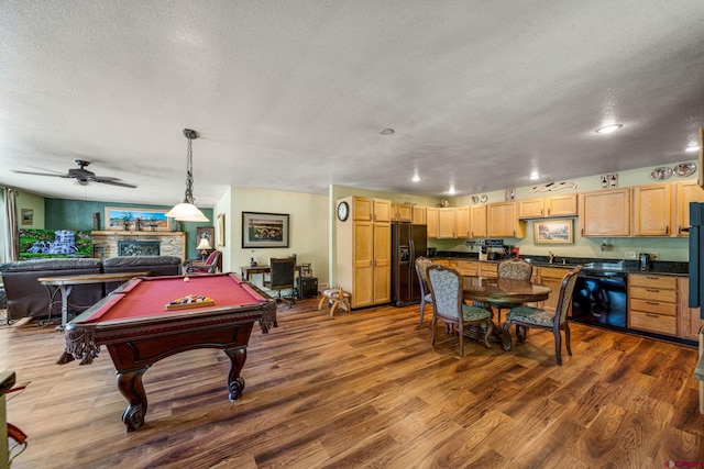 recreation room with ceiling fan, a textured ceiling, pool table, and wood-type flooring