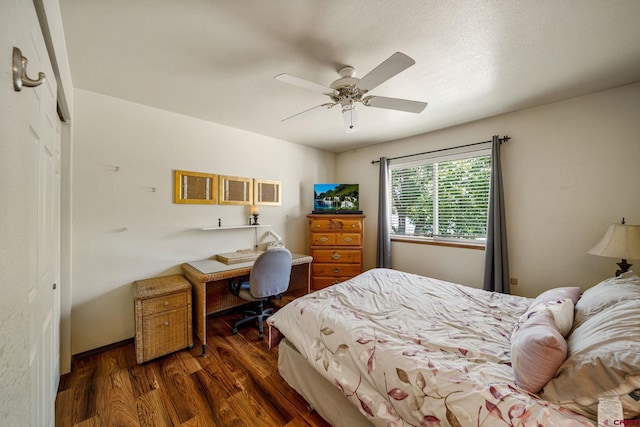 bedroom with dark hardwood / wood-style floors, a closet, and ceiling fan