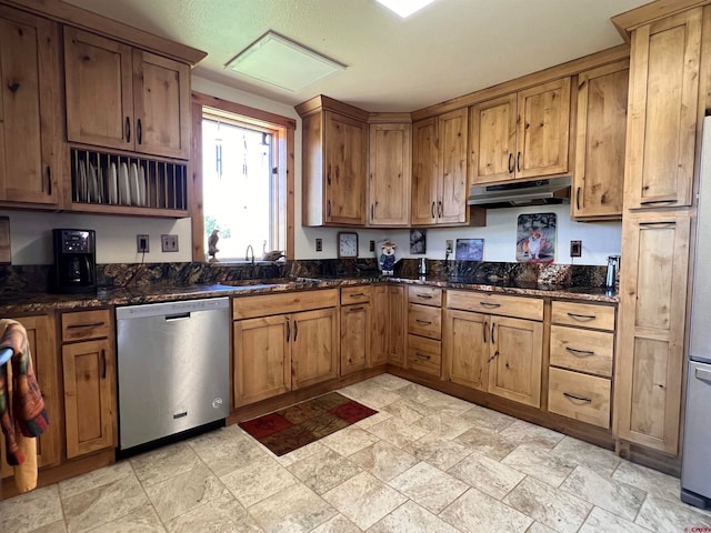 kitchen featuring dark stone counters, sink, black electric cooktop, stainless steel dishwasher, and light tile patterned floors