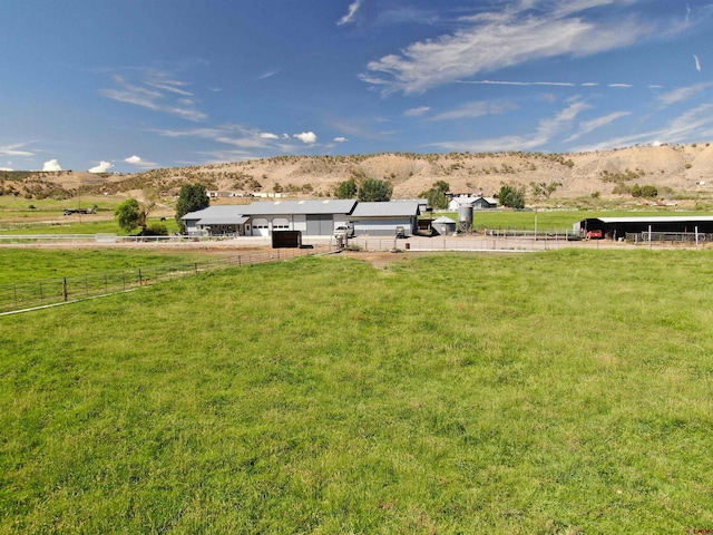 view of yard featuring a rural view and a mountain view