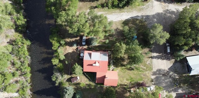 rear view of property with a yard and a garage