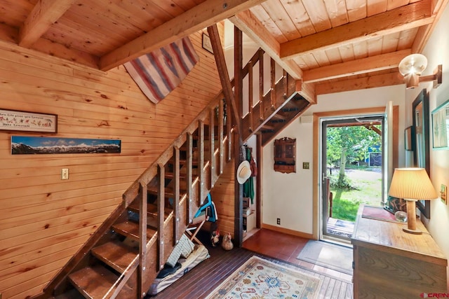 entryway with beam ceiling, wooden walls, wooden ceiling, and hardwood / wood-style floors