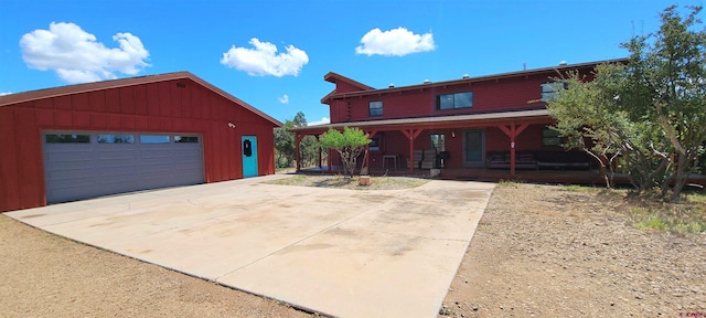 view of front of house with a porch, an outbuilding, and a garage