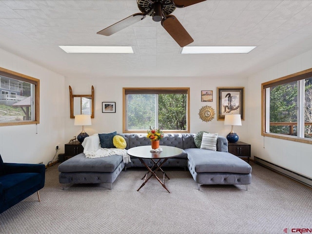 carpeted living room featuring baseboard heating and a ceiling fan