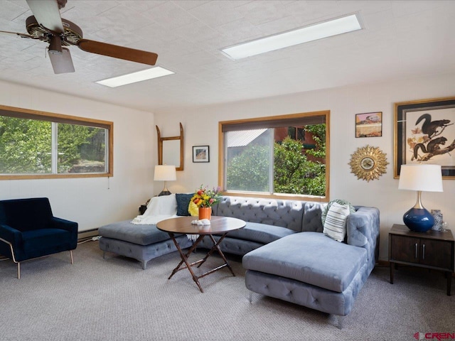 carpeted living area featuring plenty of natural light and baseboard heating