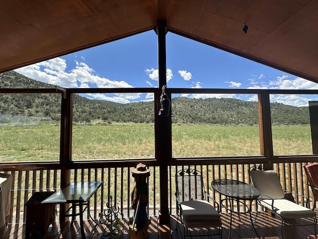 wooden deck featuring a forest view