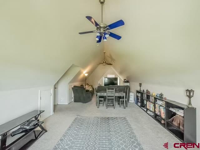 bonus room featuring vaulted ceiling, ceiling fan, and light colored carpet