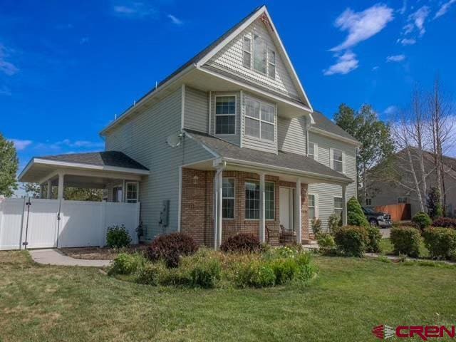 rear view of house with a yard