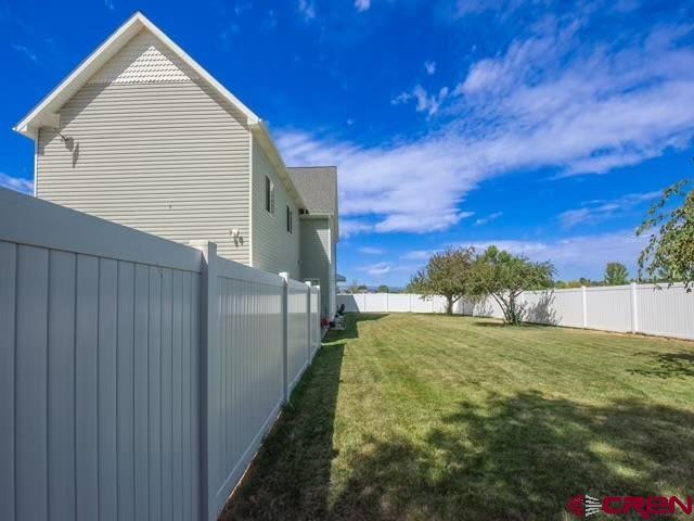 view of side of property with a yard