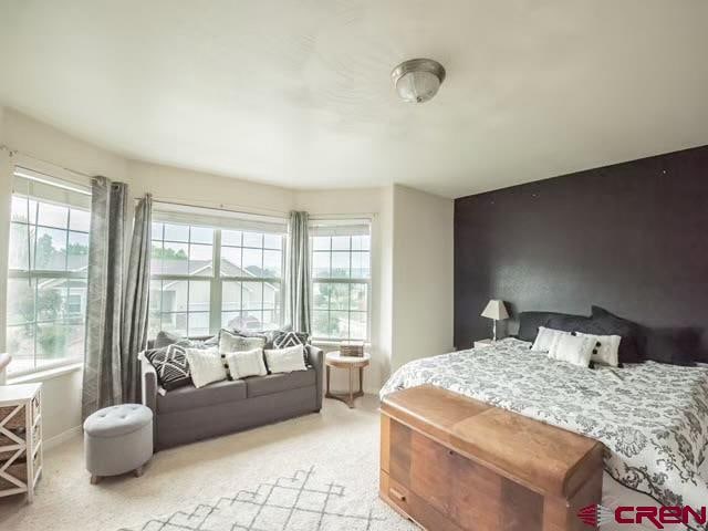 bedroom featuring multiple windows and carpet