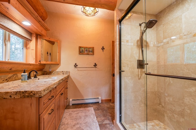 bathroom featuring a baseboard radiator, tile patterned flooring, an enclosed shower, and vanity