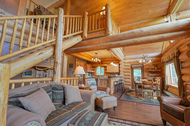 living room featuring sink, an inviting chandelier, light wood-type flooring, rustic walls, and lofted ceiling