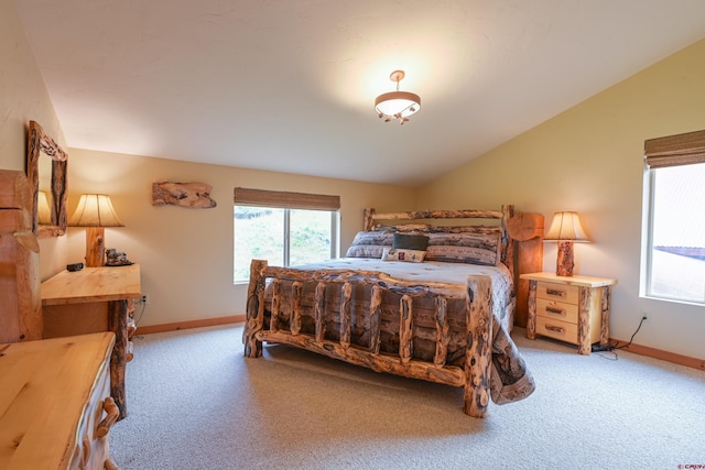 bedroom featuring light carpet and lofted ceiling