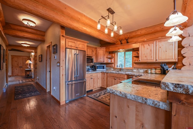 kitchen with dark hardwood / wood-style floors, stainless steel appliances, rustic walls, and hanging light fixtures