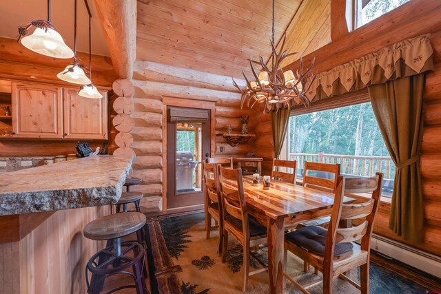 dining space featuring a towering ceiling, log walls, a healthy amount of sunlight, and a baseboard radiator