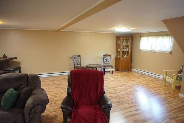 living room with ornamental molding, a baseboard heating unit, and light wood-type flooring