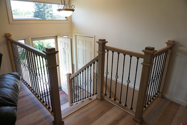 staircase with hardwood / wood-style floors