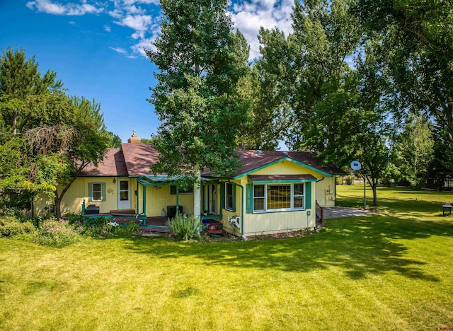 view of front of house with a porch and a front lawn