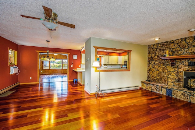 living room featuring a textured ceiling, hardwood / wood-style flooring, a baseboard radiator, and ceiling fan