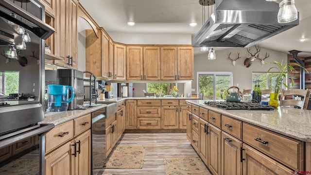 kitchen with light wood-type flooring, light stone countertops, double wall oven, stainless steel gas stovetop, and island range hood