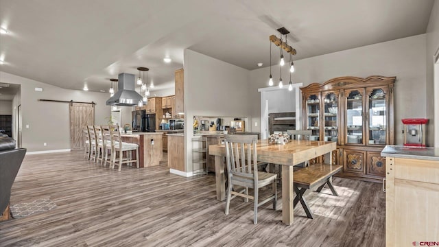 dining room featuring hardwood / wood-style flooring and a barn door