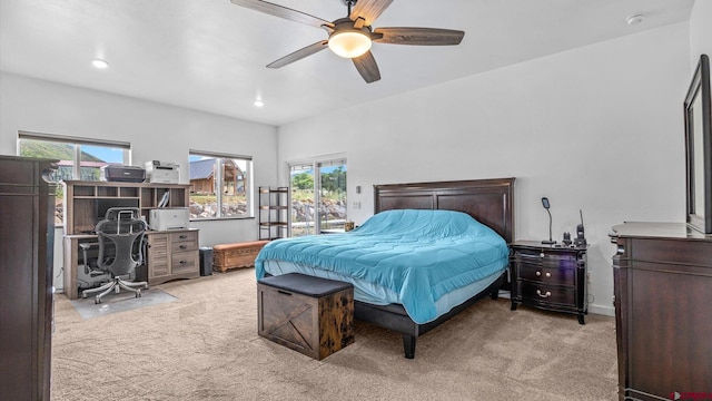 bedroom with multiple windows, light carpet, and ceiling fan